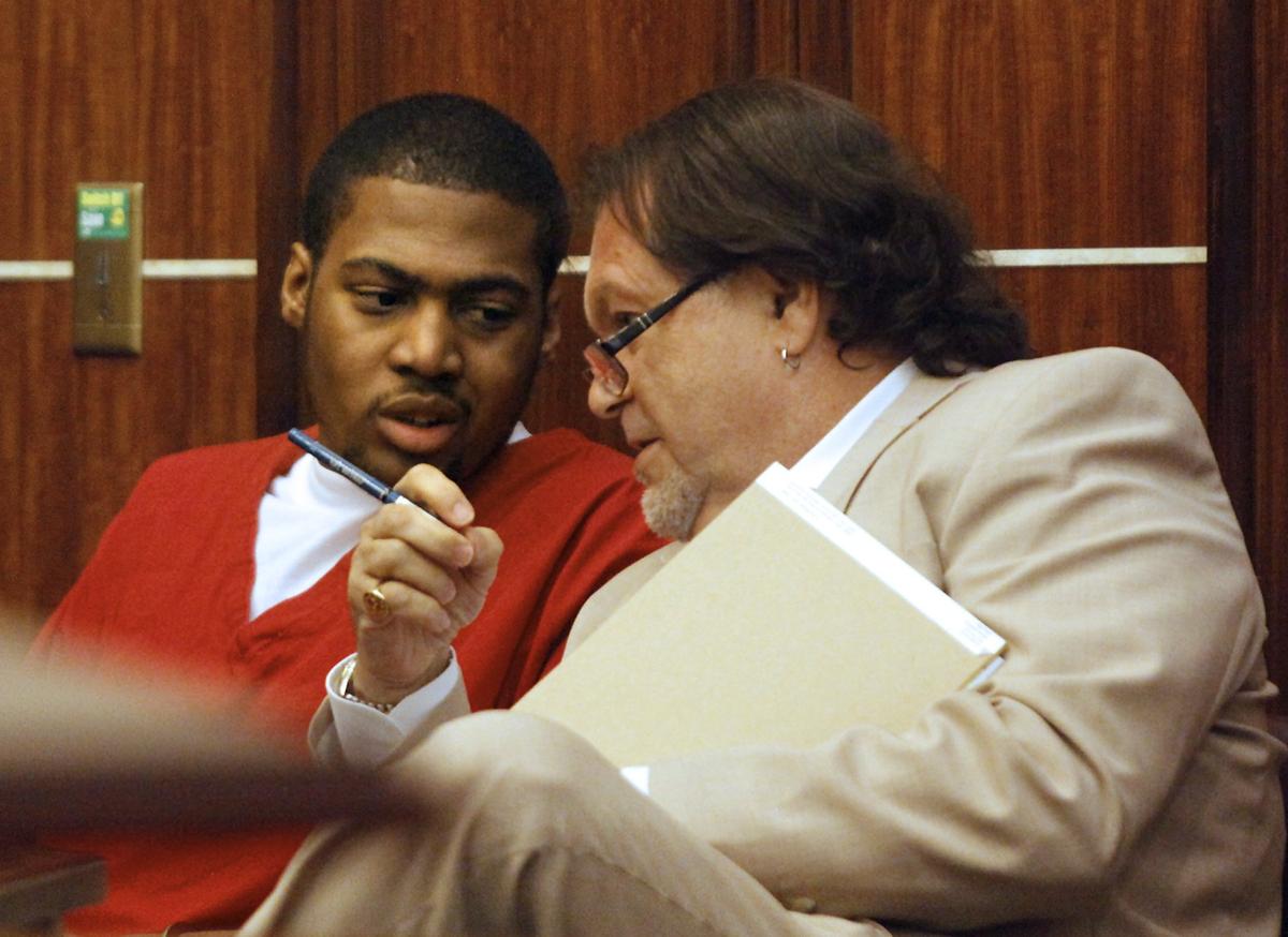 Demarcus Alexander, left, talks with his attorney, Alexander Michaels, after his pretrial hearing Friday, April 8, 2011, at the Richard E. Gerstein Justice Building, 1351 NW 12th St., Miami. Alexander was one of two men accused of fatally shooting Ciara Lee and her 2-year-old son, Devin Franklin, in December. On Friday, prosecutors Susan Dannelly and Matthew Baldwin dropped the murder charge, but said they believe Alexander violated his earlier probation for a 2007 armed robbery conviction. Alexander also was charged Friday with possession of a firearm by a convicted felon. A probation violation hearing before Circuit Judge Jorge Cueto will be within the next month; Alexander could face life in prison.