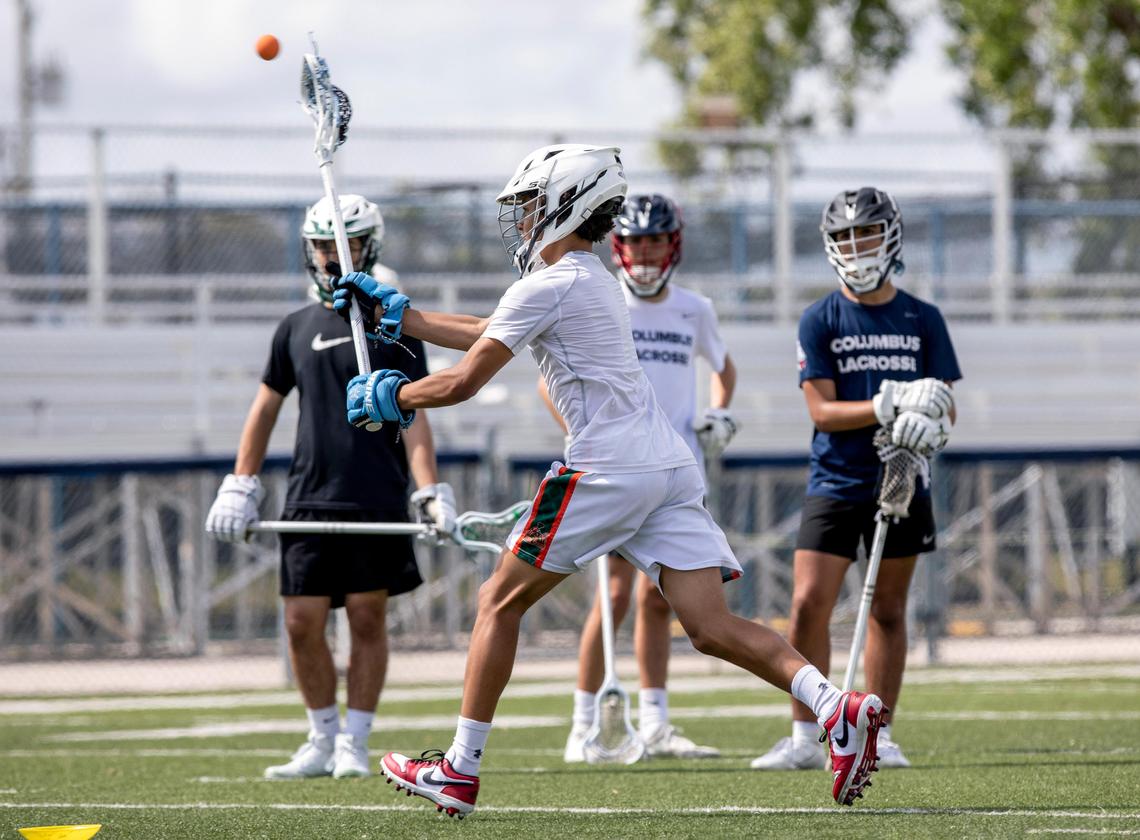 Local high school lacrosse players practice drills.