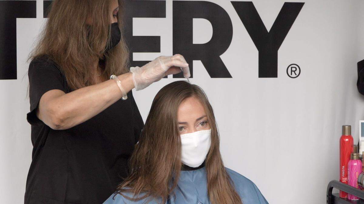 A Hair Cuttery stylist cuts South Beach’s Emily Taylor’s hair in Aventura. The salon is offering curbside cuts outdoors in Aventura.