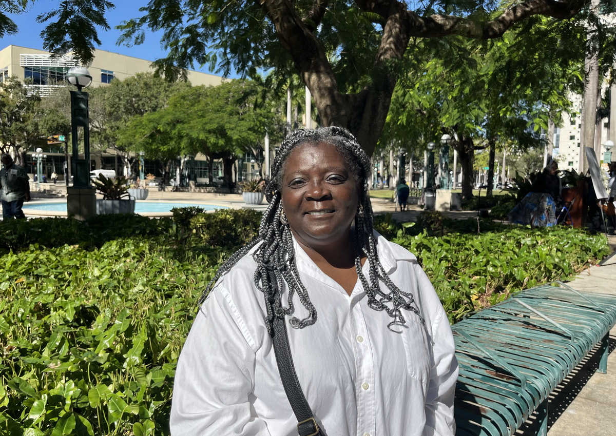 Anita Martin poses in front of the Stephen P. Clark Government Center, where the Homeless Trust, the Homeless/Formerly Homeless Forum and Miami Homes for All hosted the Homeless Persons’ Memorial Day Vigil on Friday, Dec. 20, 2024, in Miami.