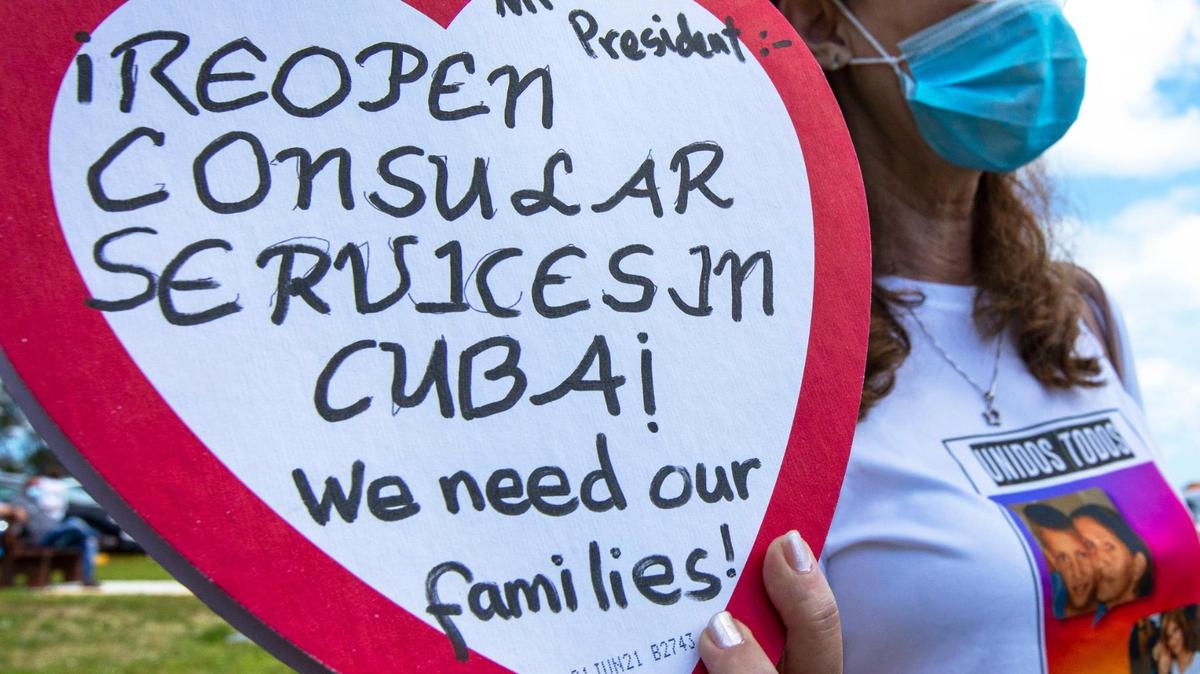 Marietta Medialdea, 59, holds a heart-shaped candy box with a message to President Biden to ‘reopen the consulate in Cuba’ while wearing a shirt with a picture of her son who is stuck in Cuba and she hasn’t seen in over eight years. Groups advocating for the Cuban family reunification program to resume and the reopening of visa services in Havana held a ‘prayer for the Cuban family’ at Ermita de la Caridad in Miami, Florida, on Sunday, March 14, 2021. 
More than 78 thousand Cubans are waiting for an immigration visa to come to the United States, while another 22,000 remain in limbo after the suspension of a family reunification program.