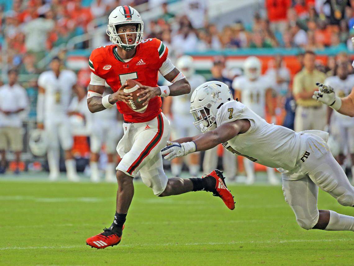 Miami Hurricanes quarterback N’Kosi Perry (5) scrambles out of the pocket as he is pursued by FIU Panthers defensive lineman Fermin Silva (7) in the fourth quarter Saturday, Sept. 22, 2018, at Hard Rock Stadium in Miami Gardens, Fla.