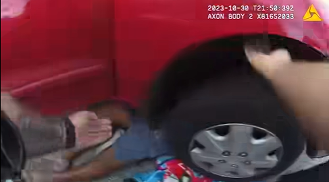 The man was working on his car when the jacks failed and the car crashed down on top of him, police video shows.