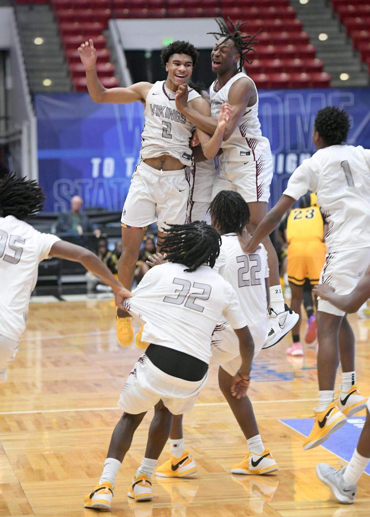 Norland’s Triston Wilson (2) and Marcus Allen (4) jump in celebration as the rest of the team runs towards them after beating Blake in the Class 5A final during the Florida High School State Championships at the RP Funding Center in Lakeland, Fl on Friday March 8, 2024. Norland defeated Blake 61-48 to win the State Title. Scott Wheeler | Photo