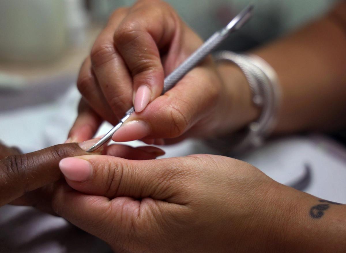 Michelle Davis, owner of Spoilt, a Miami Gardens nail salon, does the nails of Deniese Demontagnac, left, on Thursday, August 12, 2021.