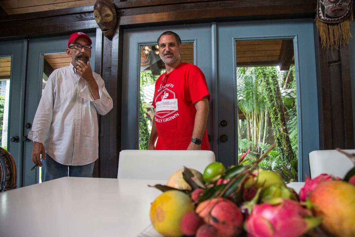 Louis Canales, left, who helped transform South Beach, talks to Taste of Redland founder Michael Huter about Redland-raised products, Tuesday, July 10, 2018.