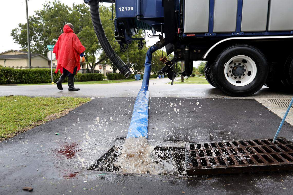 A Fort Lauderdale city truck relocates water from a nearby flooded street in the Melrose Park neighborhood in Fort Lauderdale on Friday, Oct. 10, 2025. (Carline Jean/South Florida Sun Sentinel)