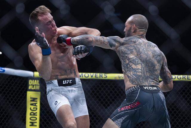 Cub Swanson of the United States and Nate Landwehr of the United States fight in their featherweight bout at UFC 327 at the Kaseya Center on Saturday, April 11, 2026, in downtown Miami, Fla.