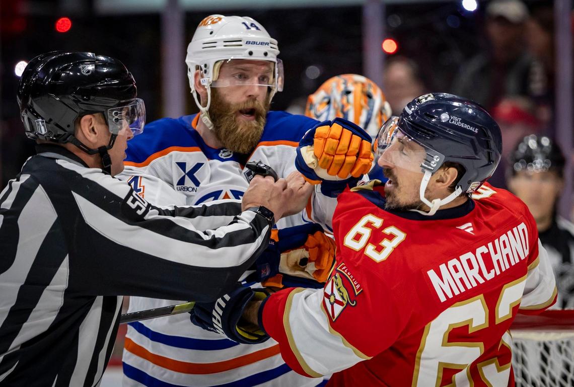 A referee separates Edmonton Oilers defenseman Mattias Ekholm (14) and Florida Panthers center Brad Marchand (63) during a scuffle in the third period of Game 3 in the NHL Stanley Cup Final series at Amerant Bank Arena on Monday, June 9, 2025, in Sunrise, Fla.