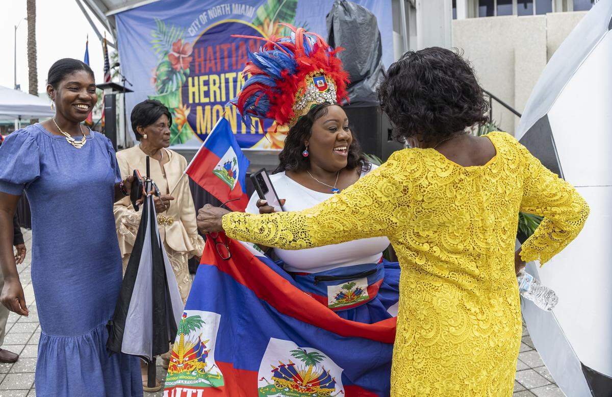 Guensine Ambo, center, dances with Vetule Jean, 79, while attending a meet-and-greet with the Haiti national soccer team at the Museum of Contemporary Art on Saturday, May 30, 2026, in North Miami, Fla.