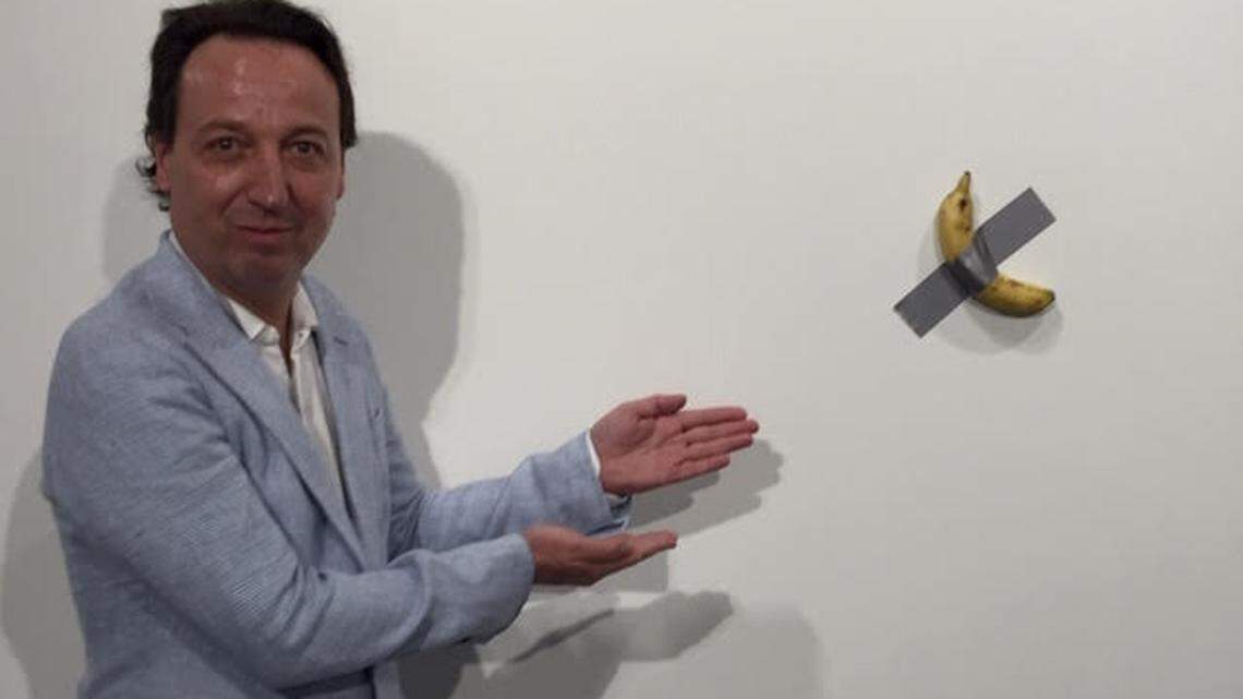 Gallery owner Emmanuel Perrotin posing with Maurizio Cattelan’s “Comedian.” List price: $120,000. Perrotin Booth at Art Basel Miami Beach, booth D24