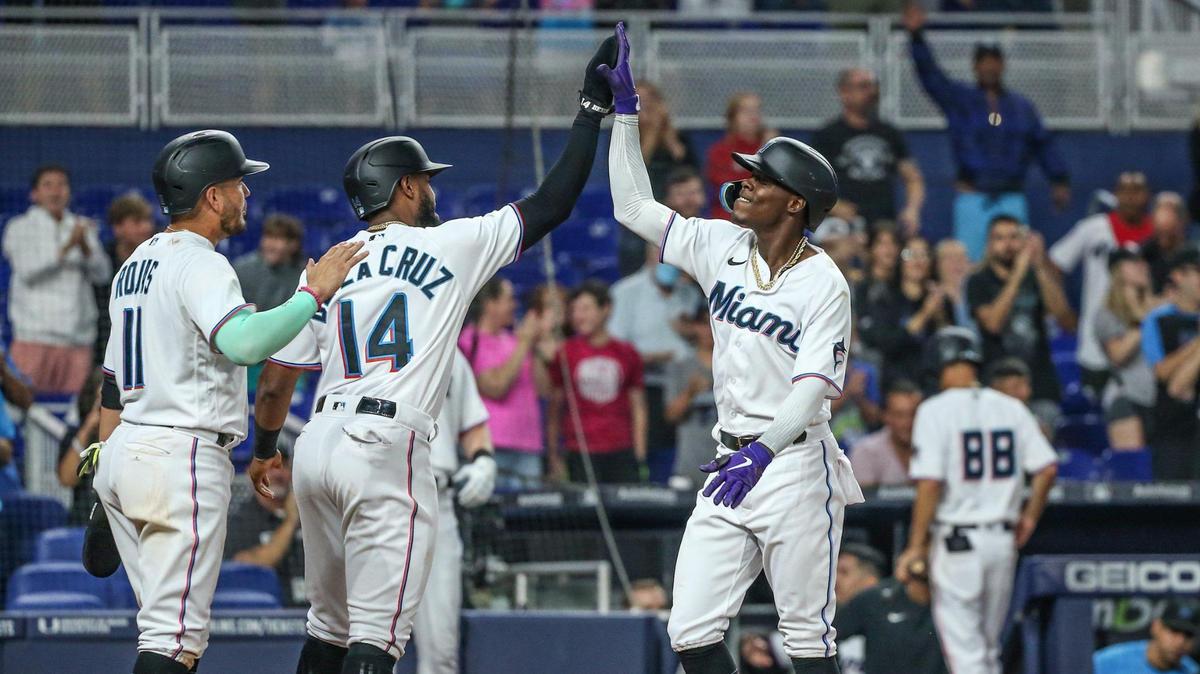 Miami Marlins second baseman Jazz Chisholm Jr. (2) celebrates at home plate after hitting a homer in the second inning bringing in shortstop Miguel Rojas (11) and center fielder Bryan De La Cruz (14) at loanDepot park in Miami on Tuesday, June 7, 2022.