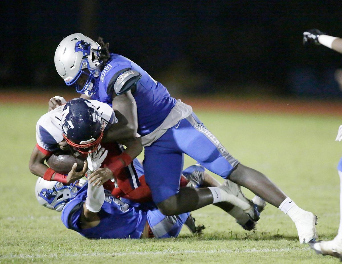 Dillard Panthers defenders tackle Miramar Patriots ball carrier during the football game on Saturday, September 23, 2023 at Dillard HS in Fort Lauderdale. Andrew Uloza / for Miami Herald