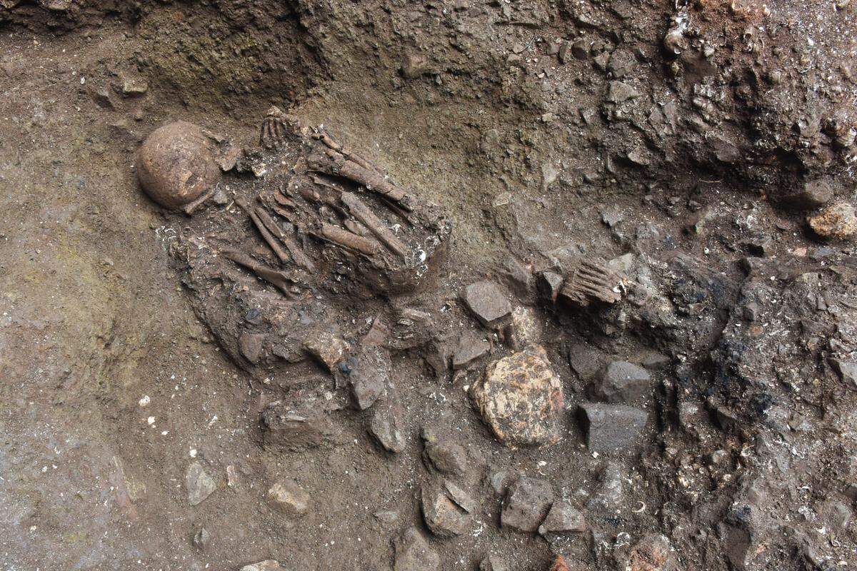 The remains were found under layers of other burials, and were significantly older than the other bodies found at the site.