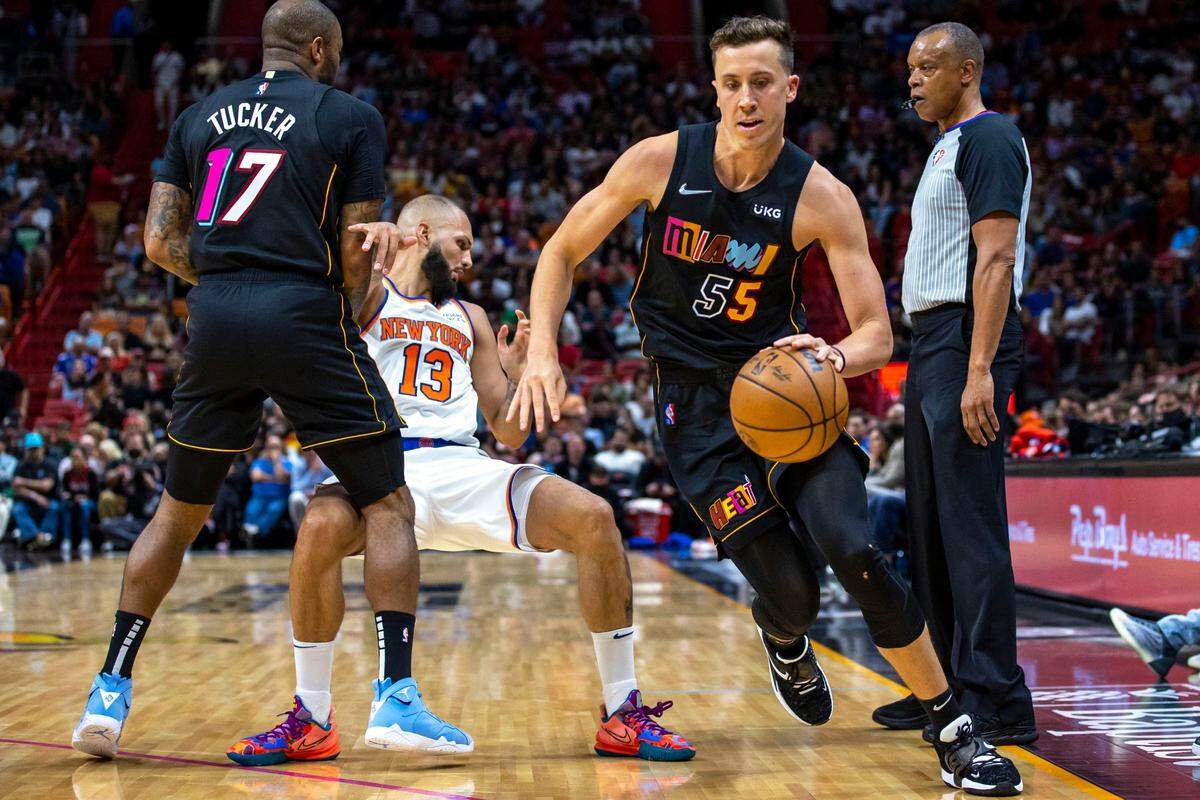 Miami Heat forward Duncan Robinson (55) is setup with the screen by teammate P.J. Tucker (17) to lose New York Knicks guard Evan Fournier (13) during the second quarter of an NBA game at FTX Arena in Miami on March 25, 2022.