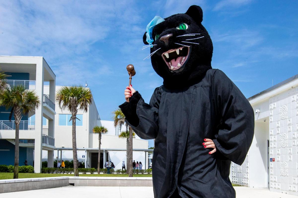 Palmetto senior Catherine Bales, 18, dressed as Penelope the Panther in a judge’s garb with gavel in hand, speaks to the media during a lunch pep rally to honor alumnus Ketanji Brown Jackson after her confirmation as Supreme Court Justice, at Miami Palmetto High School in Miami, Florida, on Friday, April 8, 2022.