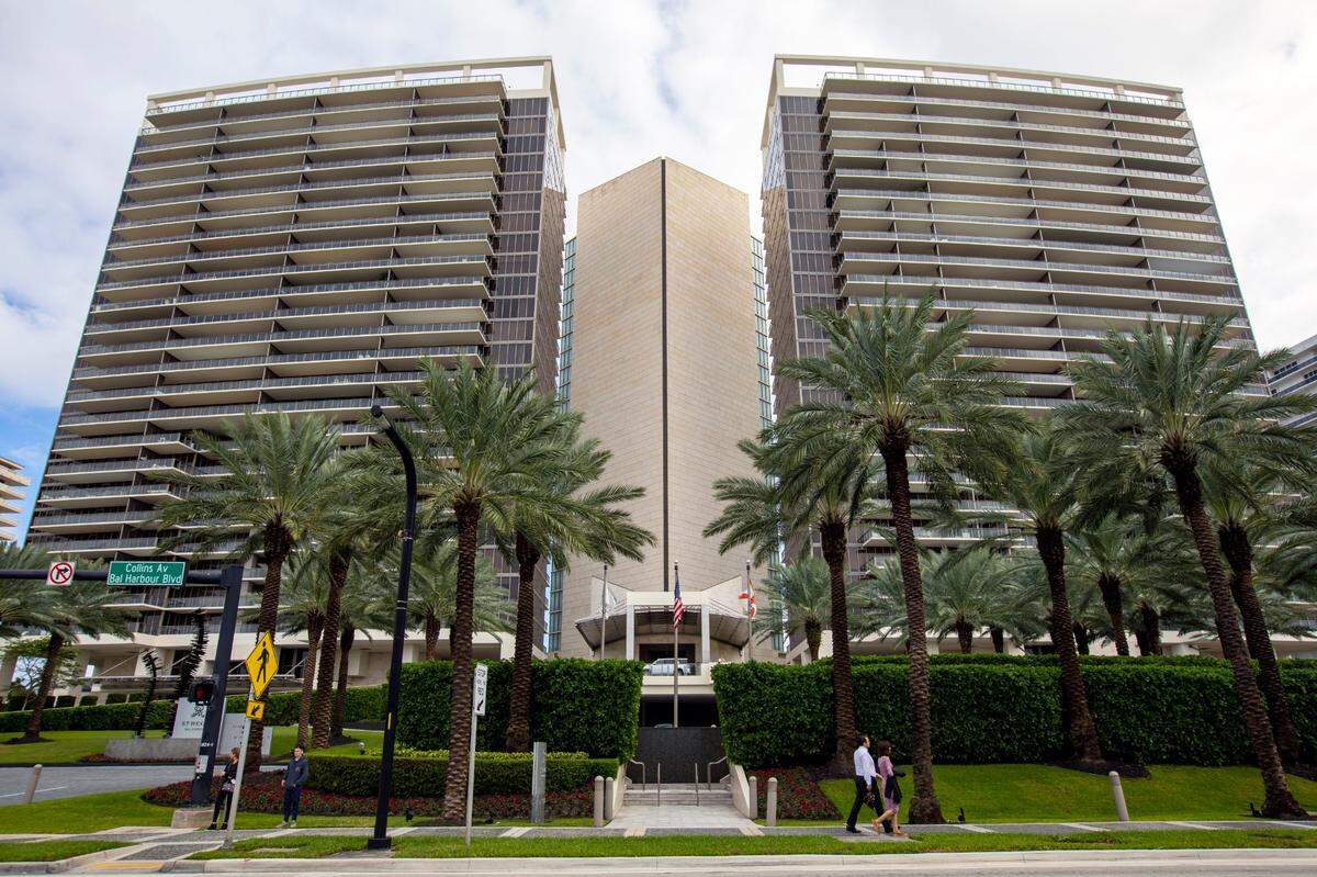 An exterior shot from Collins Avenue of people walking past the St. Regis Bal Harbour Resort, in Bal Harbour, Florida, Tuesday, November 21, 2020.