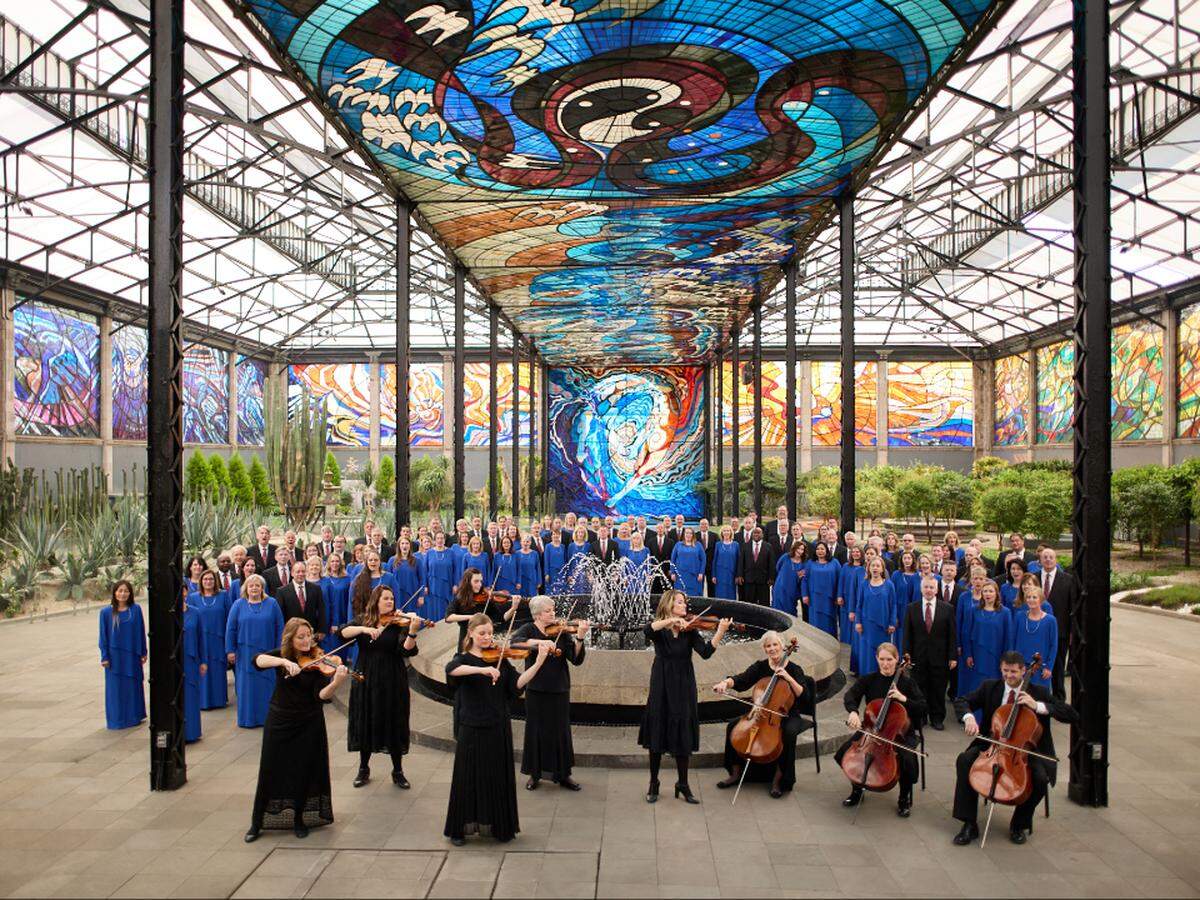 Choir and orchestra members record a music video at the Cosmovital, stained glass mural and botanical garden in Toluca, Mexico on June 14, 2023.