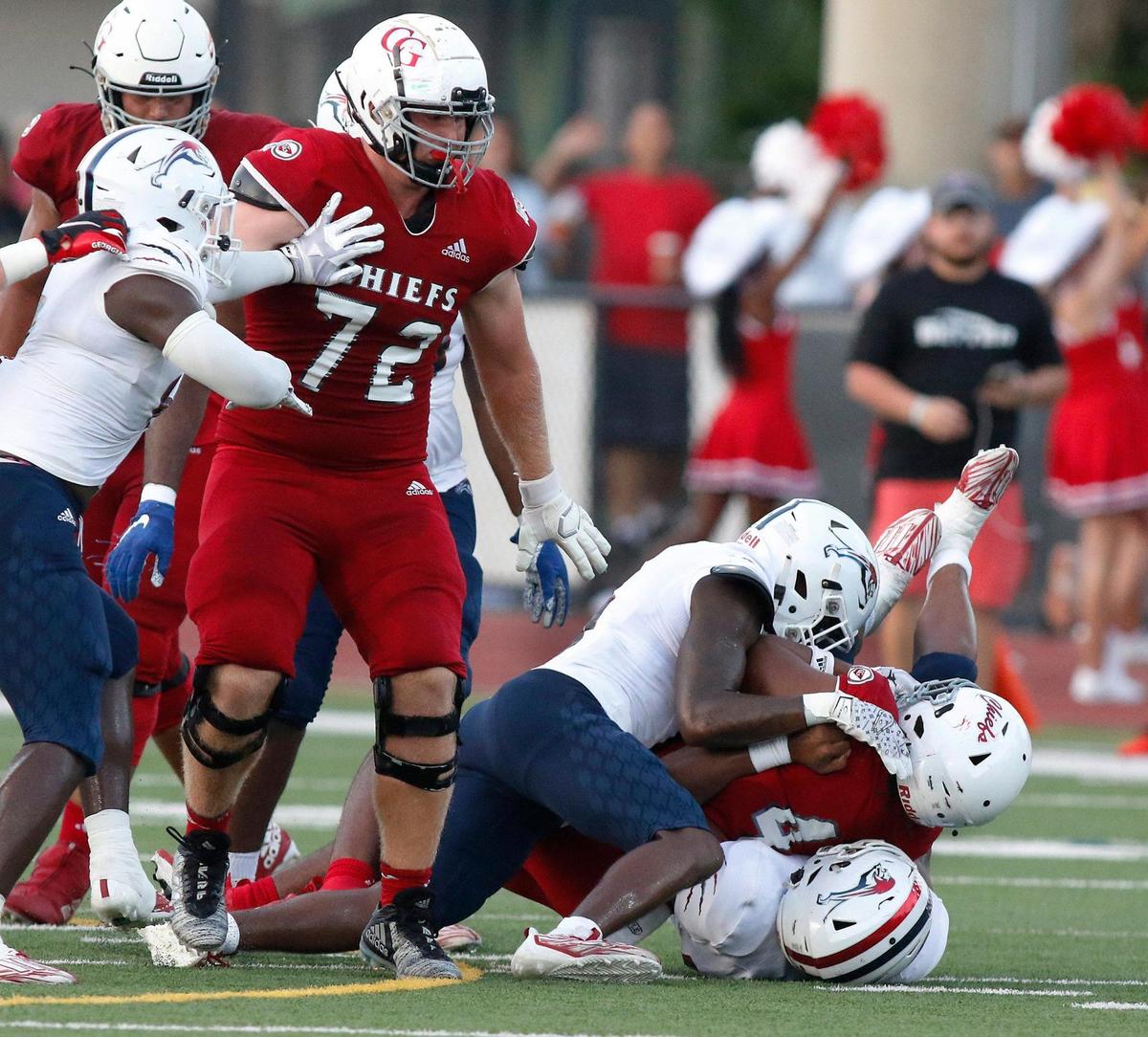 Chaminade-Madonna Lions defenders take down Cardinal Gibbons Chiefs ball carrier during the football game on Friday, September 1, 2023 at Cardinal Gibbons HS in Fort Lauderdale.