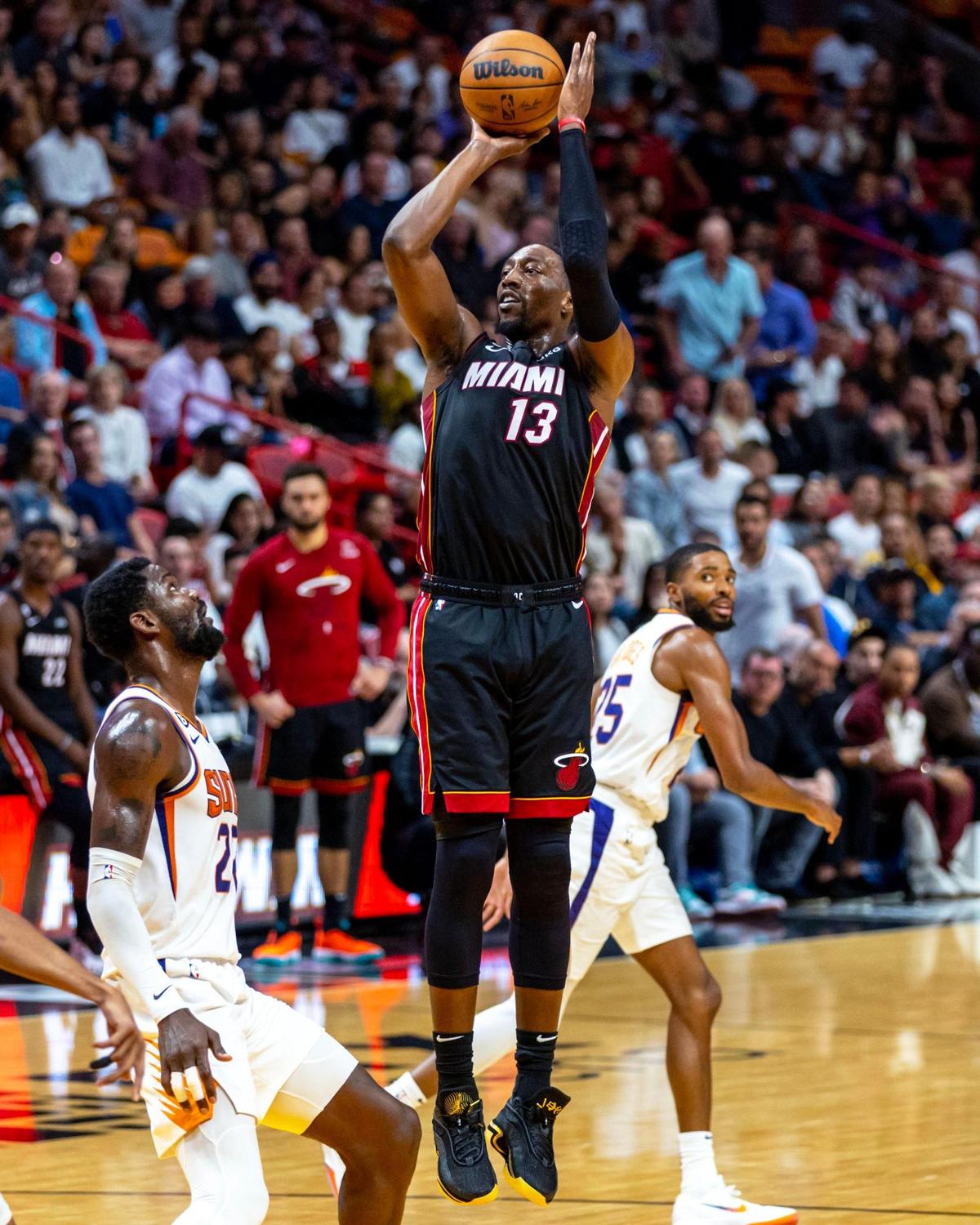 Miami Heat center Bam Adebayo (13) shoots a jumper over Phoenix Suns center Deandre Ayton (22) during the first half of an NBA game at FTX Arena in Downtown Miami, Florida, on Monday, November 14, 2022.