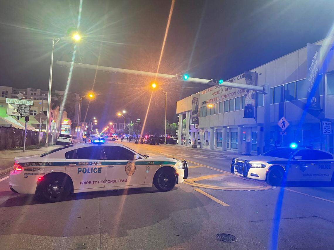Miami-Dade police cruisers block Northwest Seventh Avenue at 64th Street in Miami’s Liberty City area late Monday night after an officer was shot in the head following a car chase.