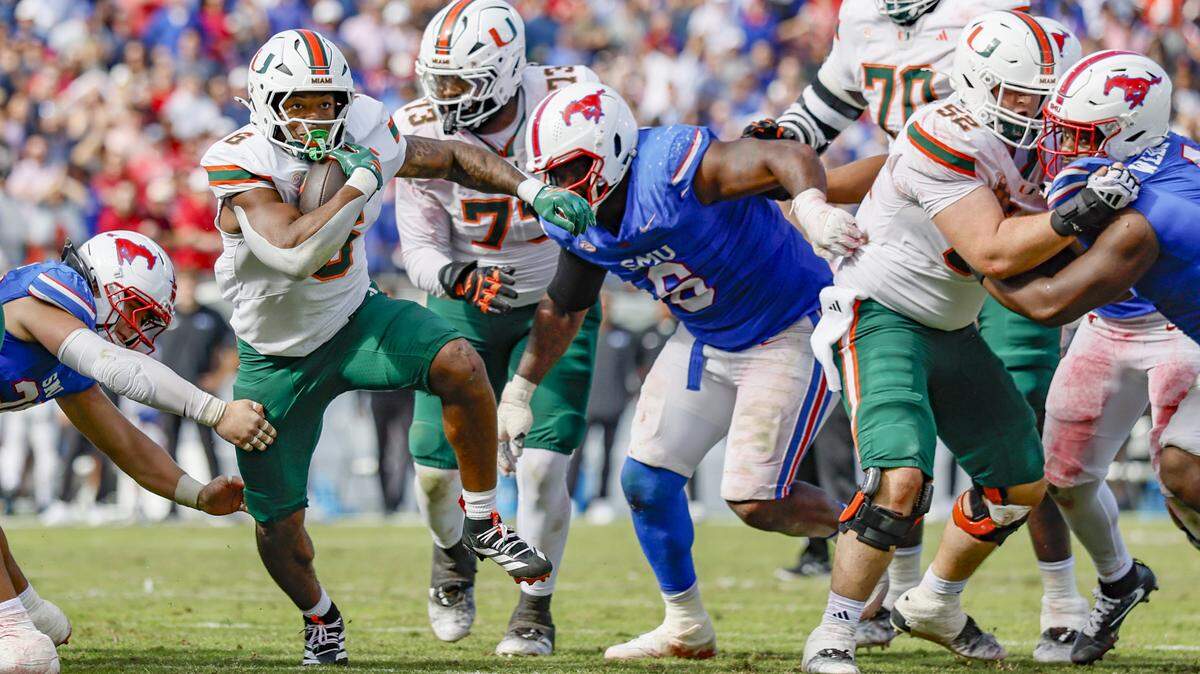Miami Hurricanes running back Charmar Brown (6) on a carry against the Southern Methodist University Mustangs in overtime during an NCAA football game at Gerald Ford Stadium on Saturday, November 1, 2025, in Dallas, Texas.