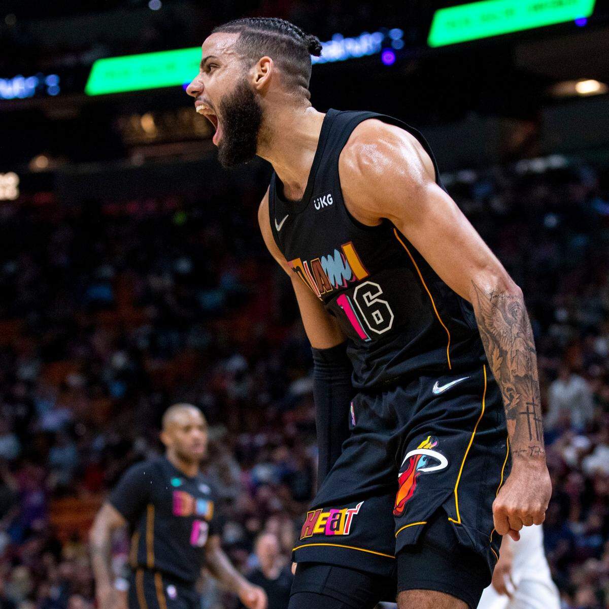 Miami Heat guard Caleb Martin (16) reacts after dunking during the fourth quarter of an NBA game against the Milwaukee Bucks at FTX Arena in Miami, Florida, on Wednesday, December 8, 2021.