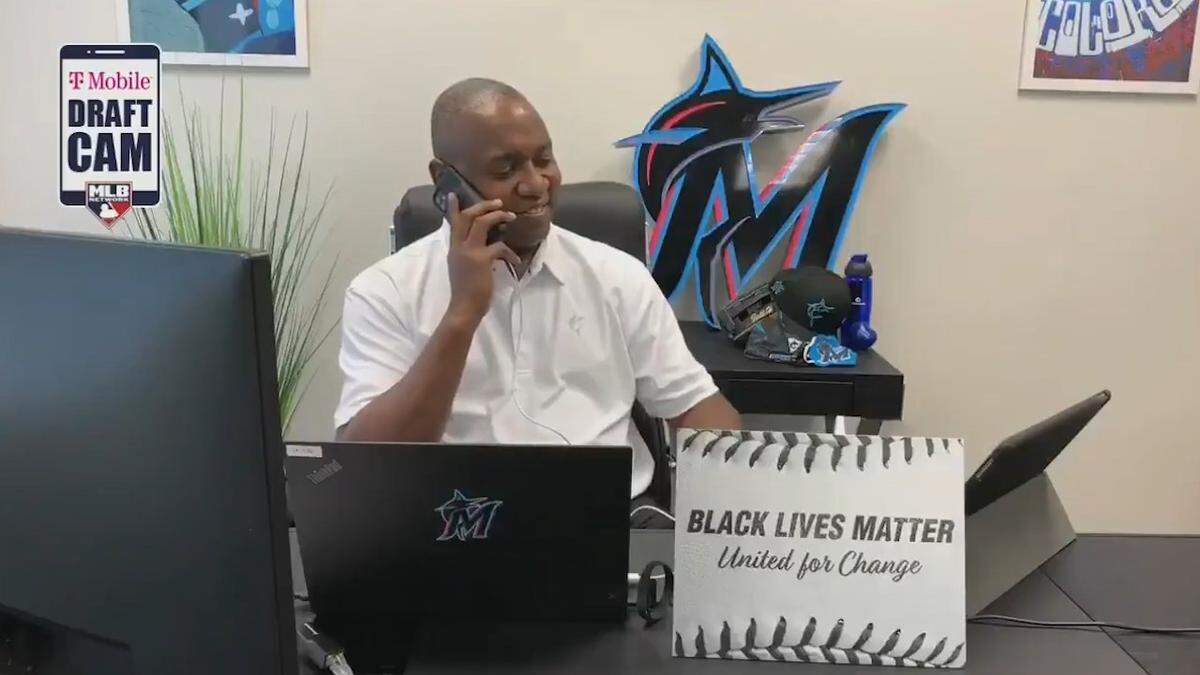 Miami Marlins president of baseball operations Michael Hill holds a “Black Lives Matter” placard from his office during the 2020 MLB Draft on Wednesday, June 10, 2020.