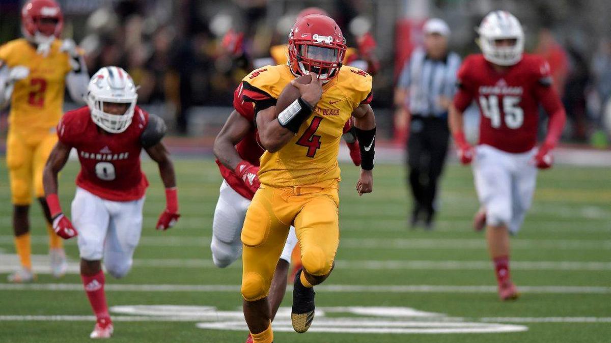 Deerfield Beach running back Jaylan Knighton breaks free from the Chaminade-Madonna defense in the season opener for both teams on Friday, Aug. 24, 2018.