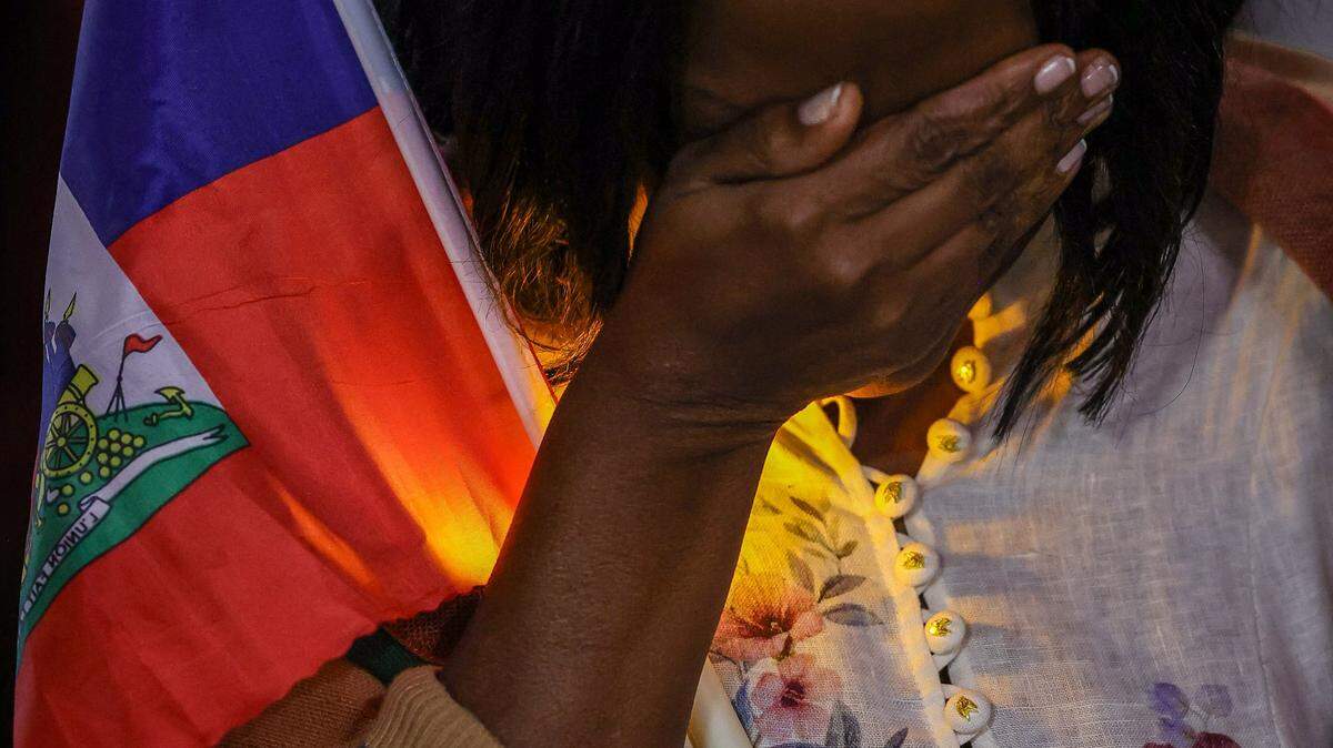 Linda Joseph, a community activist, shields her eyes while in prayer during the candlelight vigil as public officials from Miami-Dade County, the City of Miami and North Miami, along with community members, gathered for a TPS candle light prayer vigil at the Little Haiti Cultural Complex on Feb. 3, 2026, in Miami. The event, held in support of the local TPS community, included prayer, reflection and calls for unity and hope.