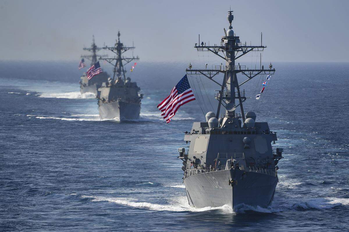 The Arleigh Burke-class guided-missile destroyers USS Preble), USS Halsey and USS Sampson under way in the Arabian Gulf.