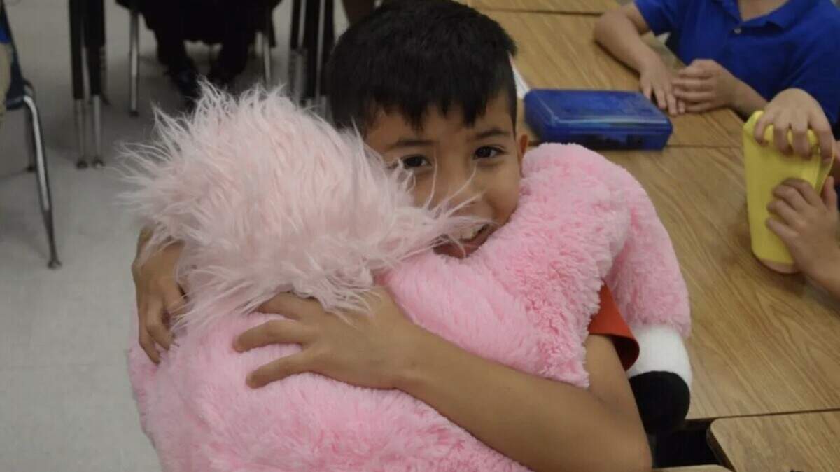 A student is comforted by a stuffed animal during a ‘Talking to Mona’ session at Dante B. Fascell Elementary School.