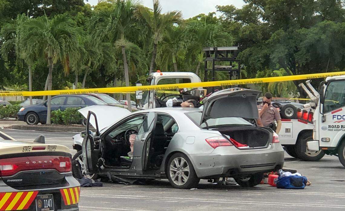 Police officers in Hialeah investigate a silver Acura found with the body of a murdered man inside the trunk. Detectives on Monday, Oct. 26, 2020, arrested Robert Coltrain, 25, on allegations that he murdered his friend, Brian Trotter, 25. Both men were from Virginia.