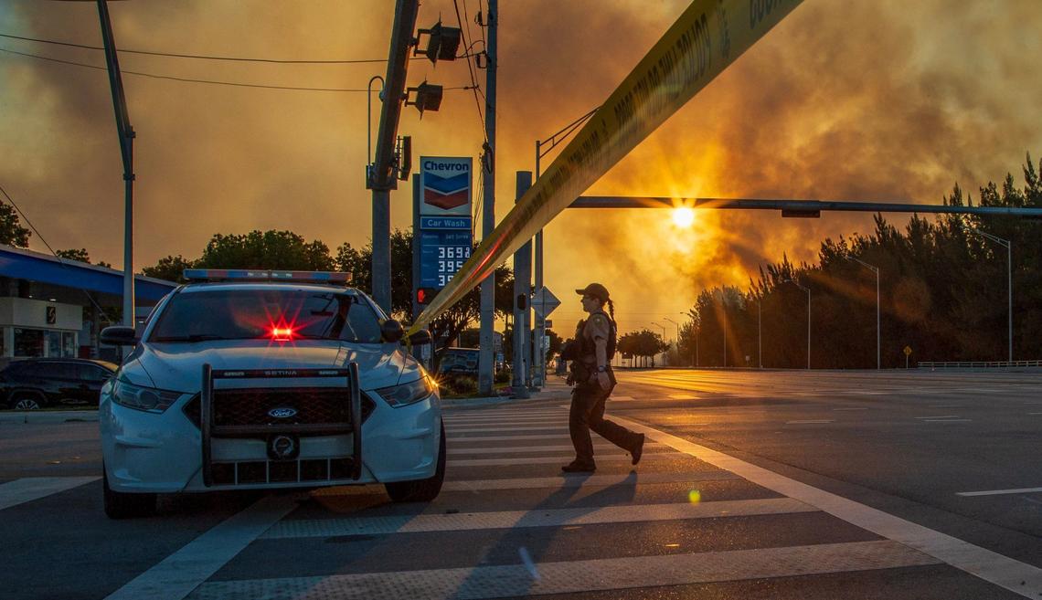 Police shut down SW 8th Street in both directions due to the heavy smoke caused by a grass fire at SW 137 Avenue and 8 Street in Miami, on Sunday, April 14, 2024.