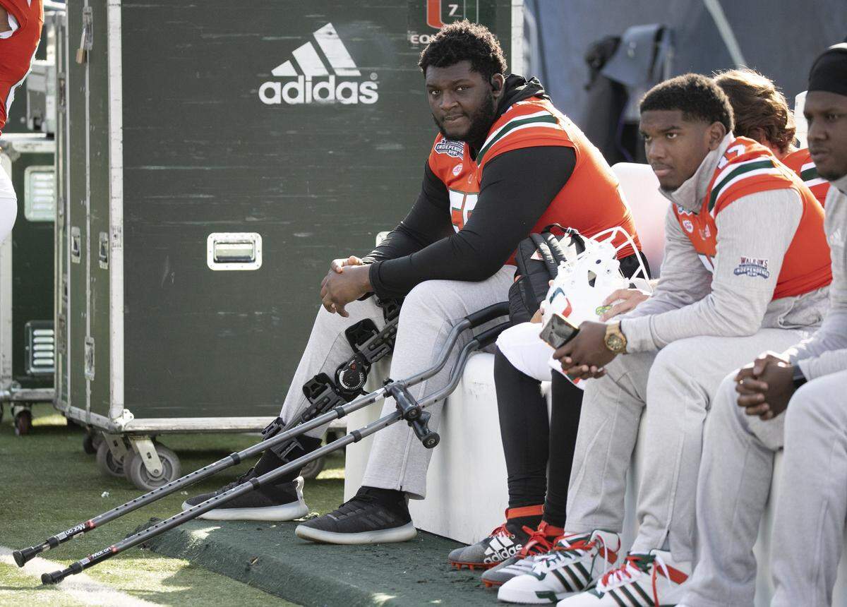 An injured Miami Hurricanes offensive lineman Navaughn Donaldson (55) watches the game as the Miami Hurricanes play Louisiana Tech in the Independence Bowl at Independence Stadium, Shreveport, Louisiana on Thursday, December 26, 2019.