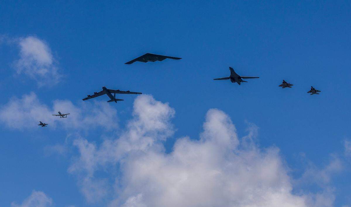 Several U.S. military aircraft, including the U.S. Air Force Northrop B-2 Spirit (center), soar over South Beach during the Hyundai Air & Sea Show, part of Miami Beach’s annual National Salute to America’s Heroes, on Saturday, May 24, 2025.
