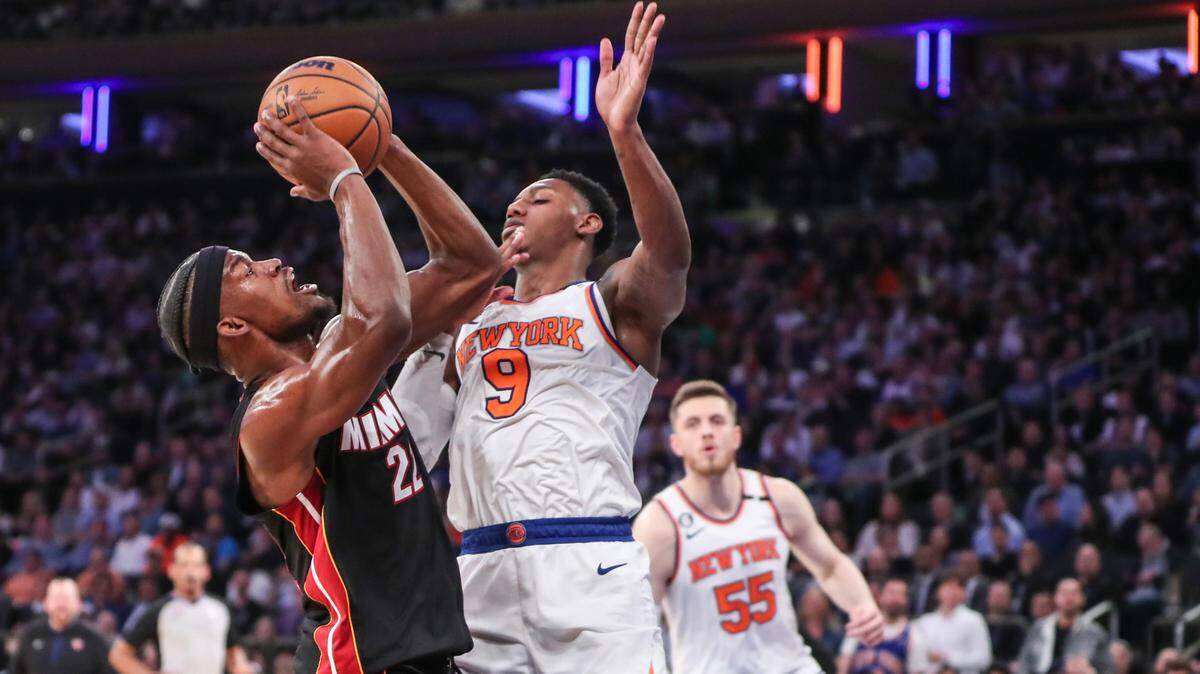 Miami Heat forward Jimmy Butler (22) goes up against New York Knicks guard RJ Barrett (9) during game five of the 2023 NBA playoffs at Madison Square Garden.