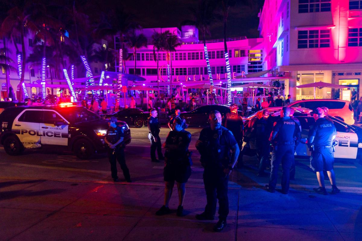 Miami Beach police officers arrest a man after he was apparently blocking traffic on Ocean Drive on Friday, March 3, 2023.
