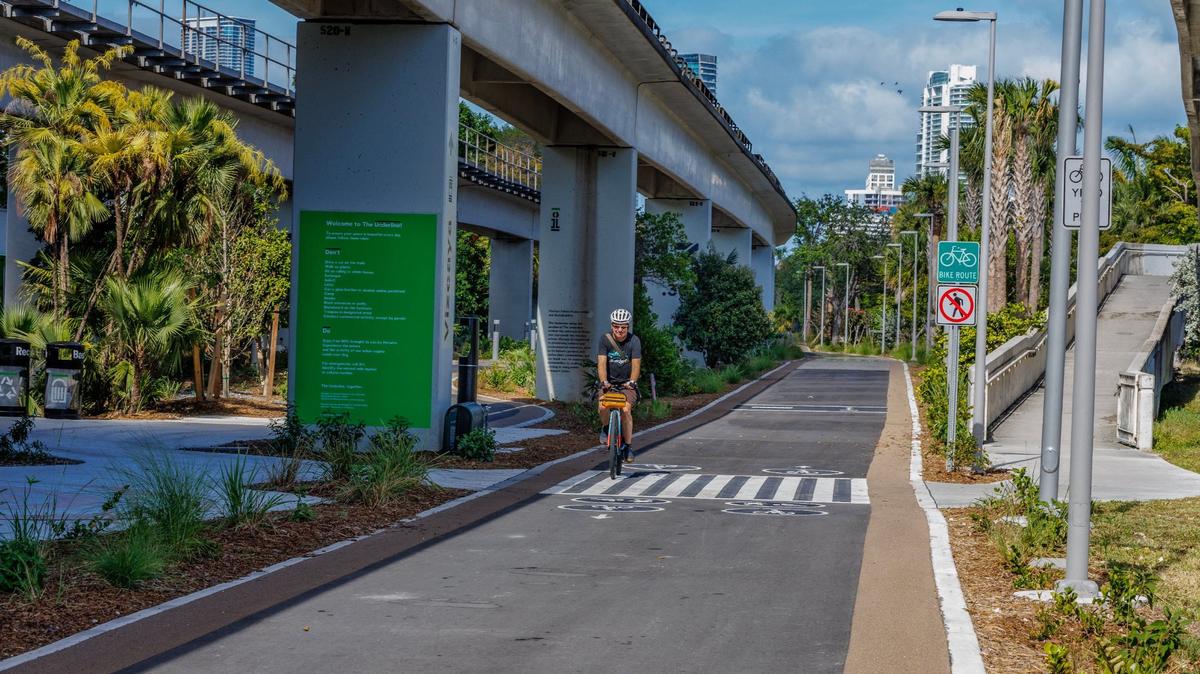 Miami Herald reporter Andres Viglucci rides through The Underline Phase 2 by the Vizcaya Station Plaza, part of a 2.14-mile segment that connects SW 13th St. to SW 19th Ave, ahead of the official opening on April 23rd, on Wednesday April 17, 2024.