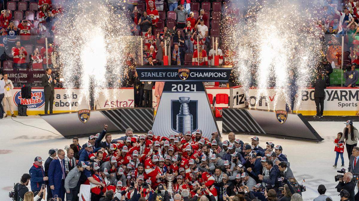 The Florida Panthers team poses with the Stanley Cup trophy after defeating the Edmonton Oilers in Game 7 of the NHL Stanley Cup Final at the Amerant Bank Arena on Monday in Sunrise, Fla. Bill Zito’s roster construction, Paul Maurice’s coaching and the team’s overall buy in paved the way for the Florida Panthers’ first Stanley Cup.