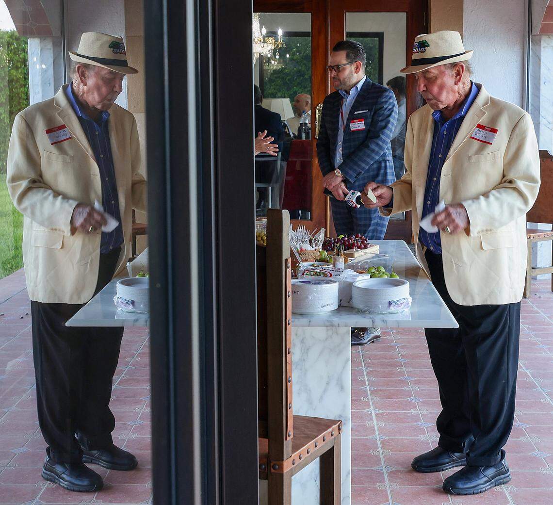 Miguel Villalobos, right, takes moment to sample the hors d'oeuvres as he and other Cuban and Cuban-American entrepreneurs gathered for a private event on Tuesday, March 31, in Miami, to organize and pledge to invest in Cuba if there is a change in government.