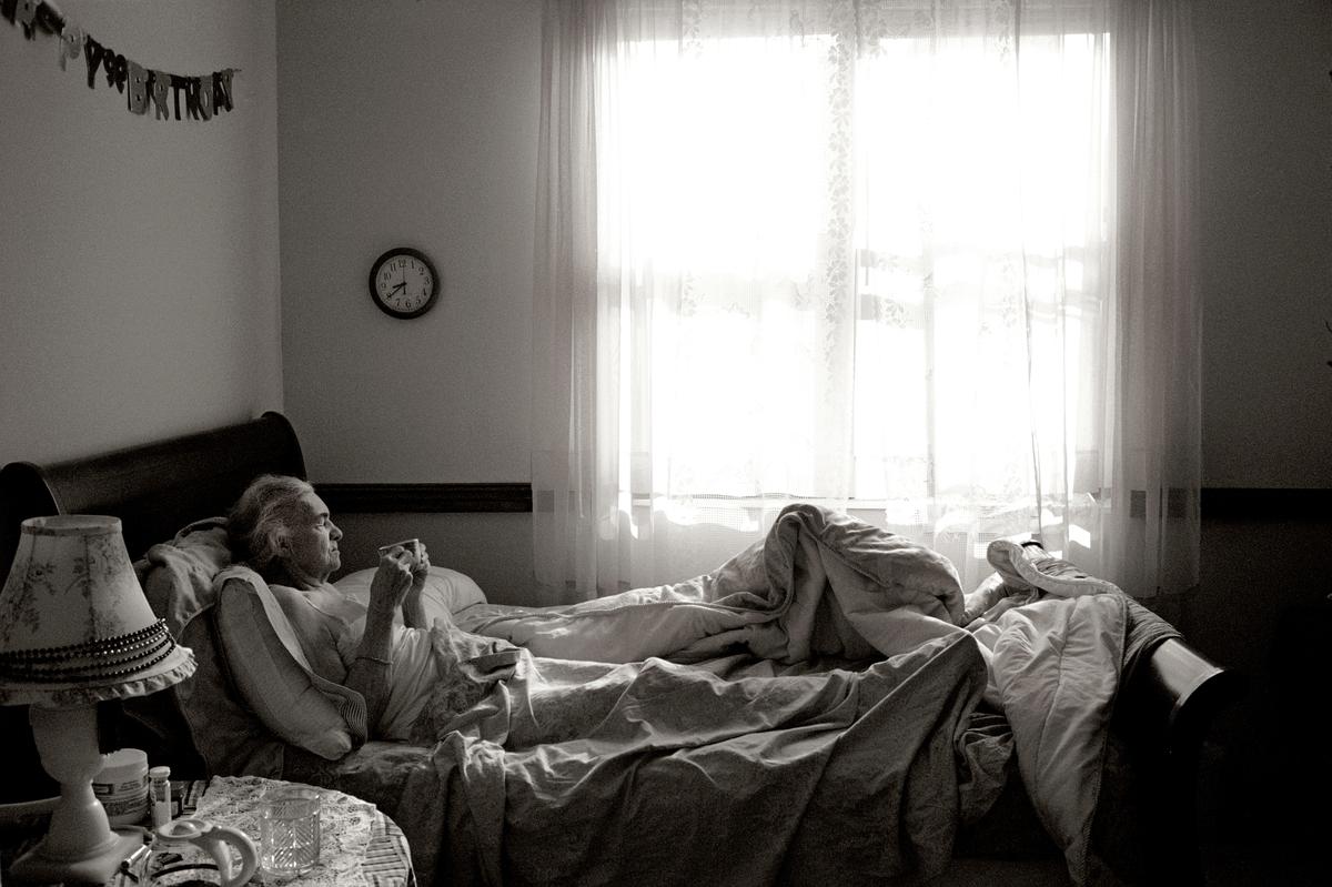 June 2007: Maggie Steber’s mom, Madje Steber, who suffered from dementia, enjoys breakfast in bed. When Madje started losing her memory in 2003, Maggie, an award-winning photographer, moved her from Texas to Miami to care for her and document her decline through photography.