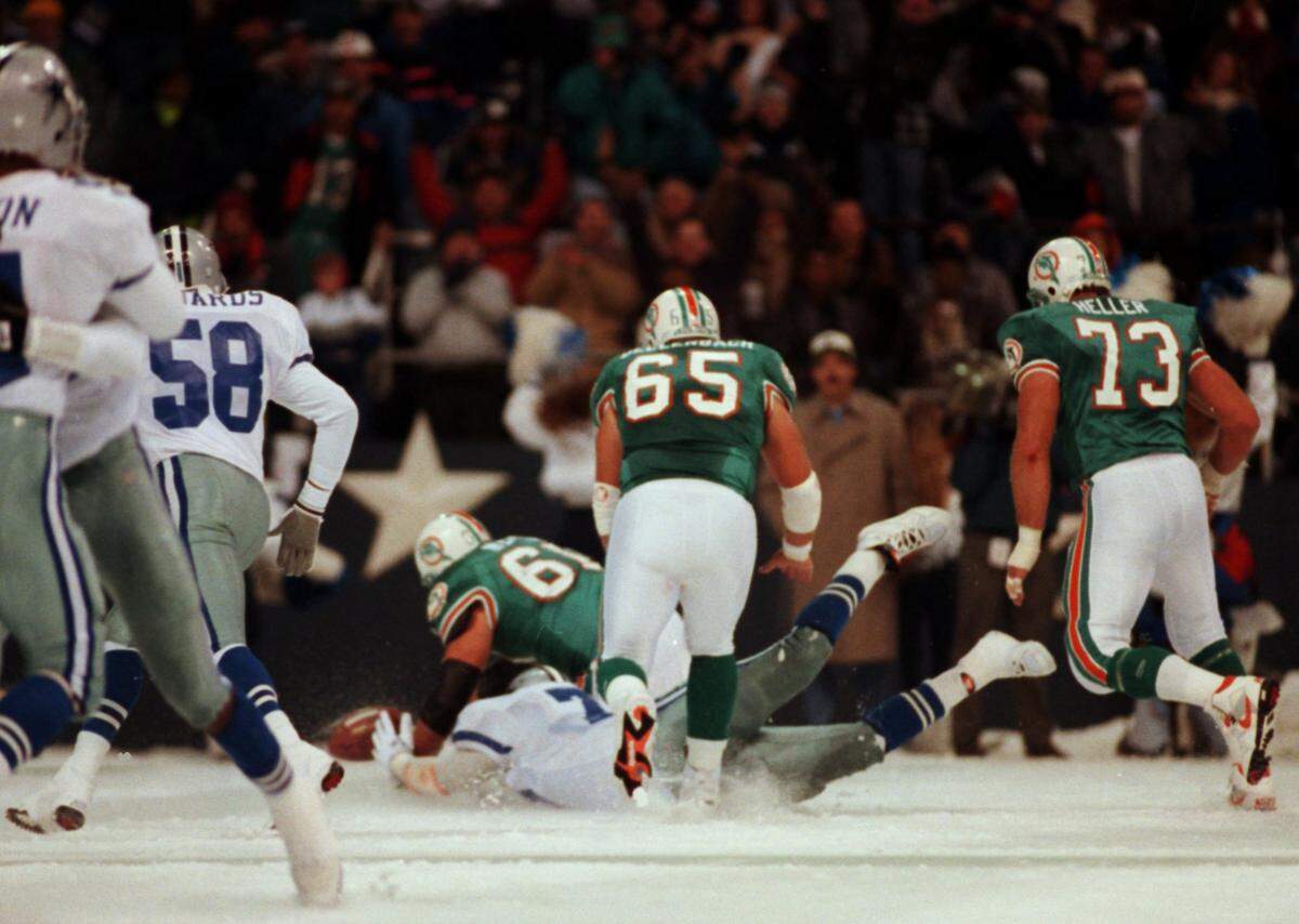 Leon Lett goes after the ball even as his teammates celebrate the blocked kick. Chasing are Cowboys Dixon Edwards, Dolphins Jeff Dellenbach (65) Ron Heller (73) and Eddie Blake on top of Lett.