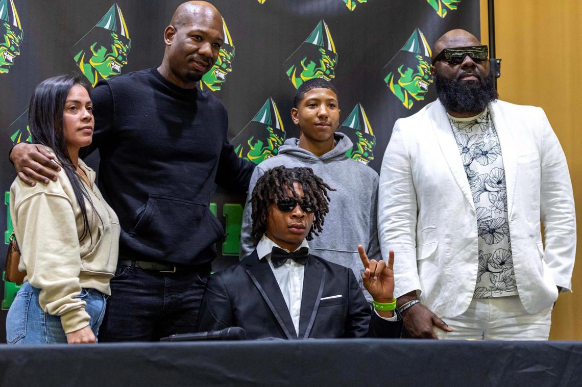 Miami Central’s Herlin Perry and his family react after he signed with University of South Florida during signing day at Miami Central High School on Wednesday, Dec. 4, 2024, in Miami, Fla.