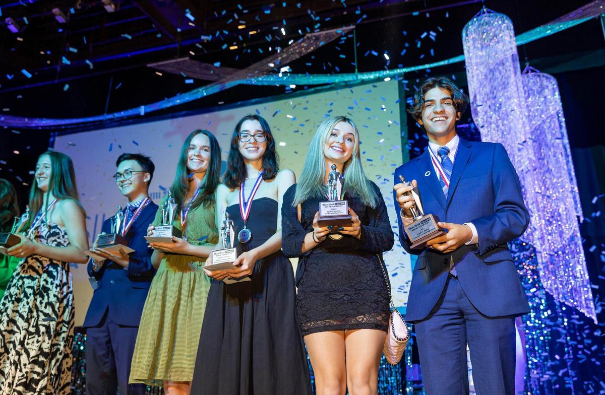 Silver Knight Award winners celebrate on stage after receiving their awards during the Miami Herald & el Nuevo Herald 65th Silver Knight Award Ceremony at the James L. Knight Center on Thursday, May 25, 2023, in downtown Miami, Fla.
