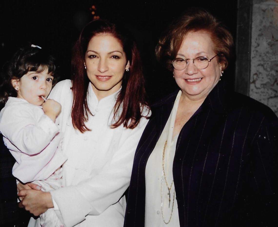 Emily Estefan, when she was little and in her mother Gloria Estefan’s arms and Gloria’s mother, Gloria Fajardo, in a family album photo of three generations of Estefan women.
