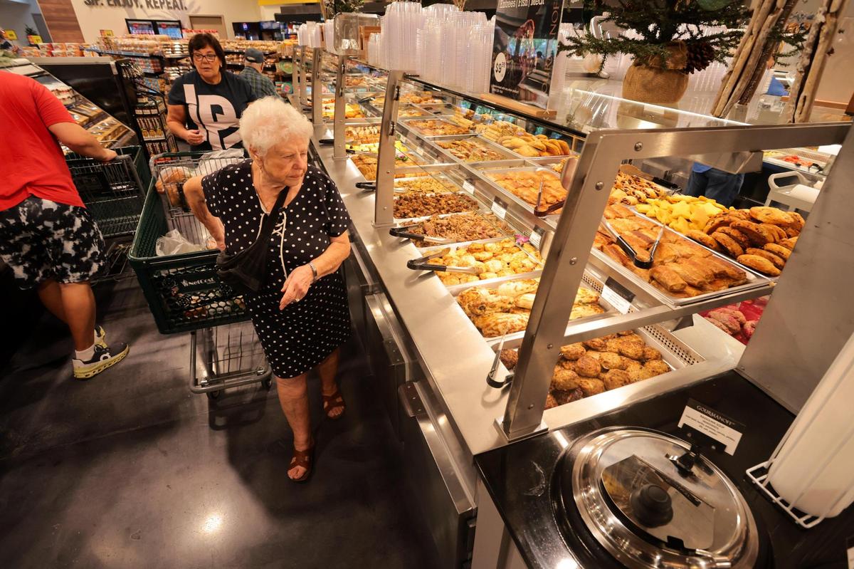 A costumer walks around the hot food section at NetCost Market in Hollywood, Florida, on Thursday, Dec. 19, 2024.
