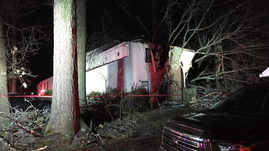 The tree crashed into the rear corner of the home, the fire department officials said.