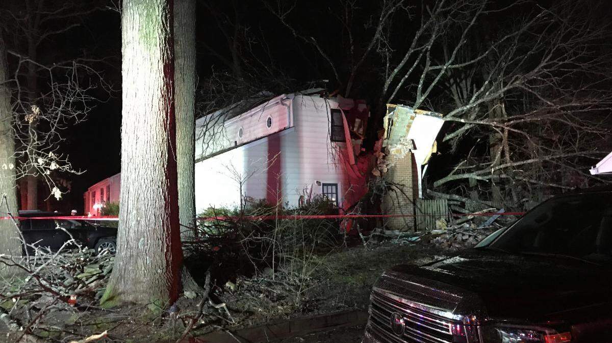 The tree crashed into the rear corner of the home, the fire department officials said.