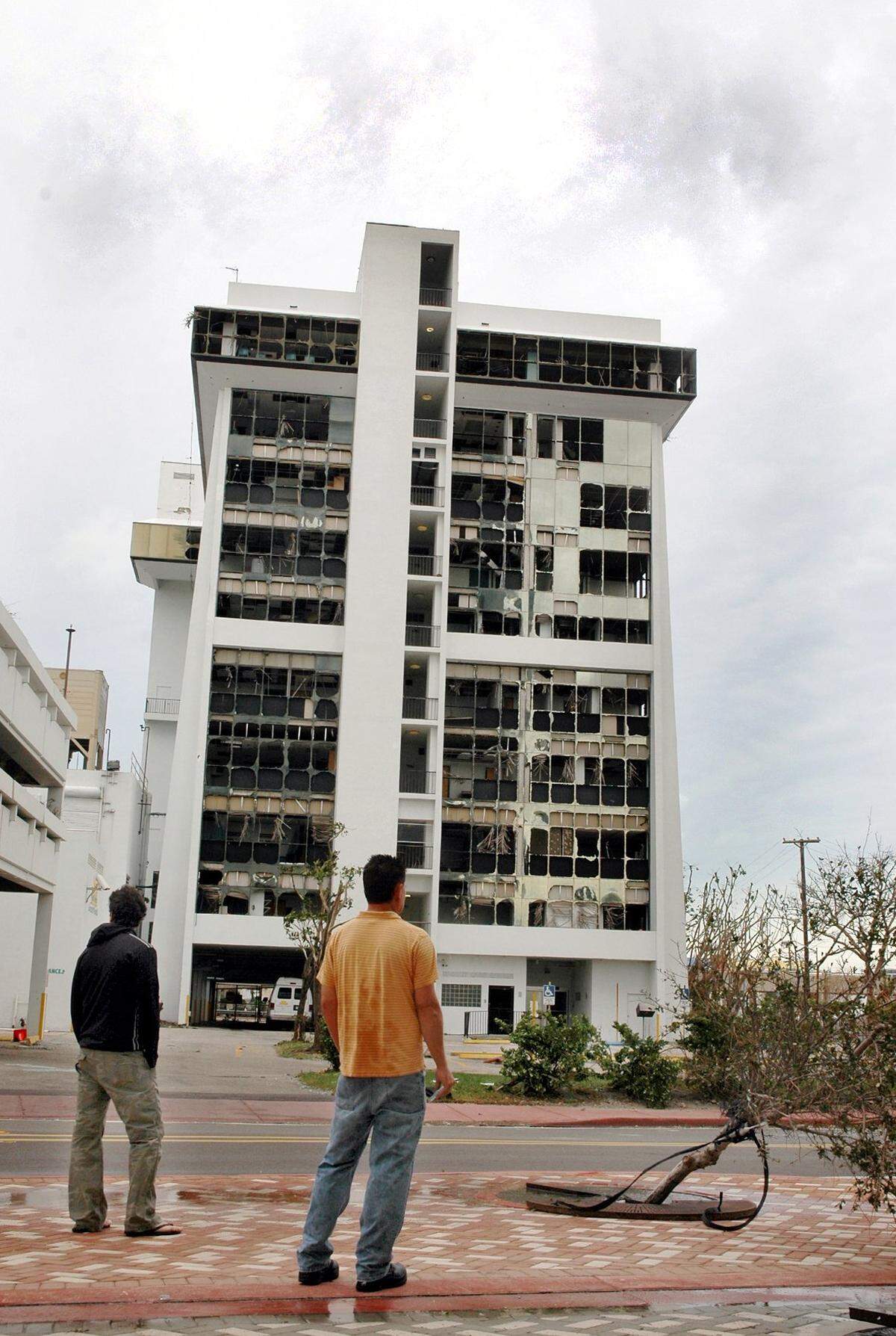 Residents look over devastated South Shore Hospital on Fifth Street and Alton Road in South Beach. The windows on the entire west side of the building were blown out by the powerful winds of Hurricane Wilma.